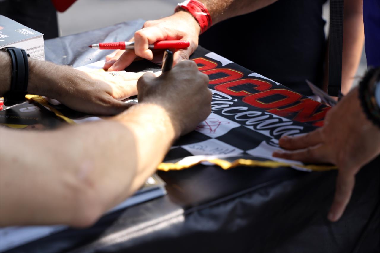 James Hinchcliffe signing an autograph for a fan -- Photo by: Joe Skibinski
