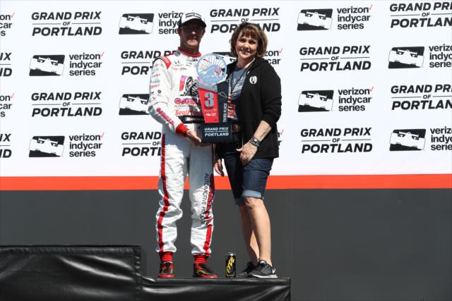 Sebastien Bourdais is presented his 3rd Place trophy in Victory Circle following the Grand Prix of Portland at Portland International Raceway -- Photo by: Chris Jones