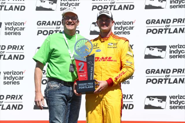 Ryan Hunter-Reay is presented his 2nd Place trophy in Victory Circle following the Grand Prix of Portland at Portland International Raceway -- Photo by: Chris Jones