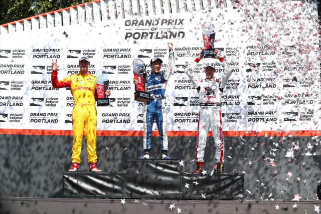 The confetti flies over Takuma Sato, Ryan Hunter-Reay, and Sebastien Bourdais in Victory Circle following the Grand Prix of Portland at Portland International Raceway -- Photo by: Chris Jones