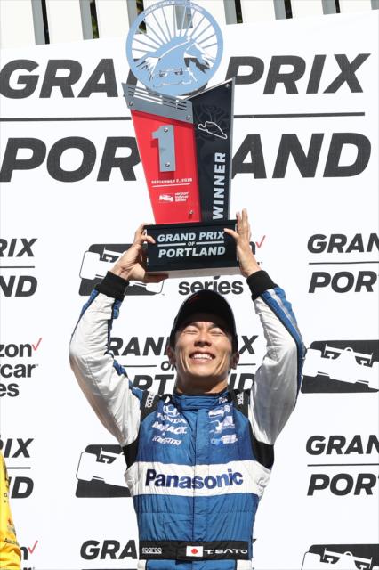 Takuma Sato hoists his 1st Place trophy in Victory Circle after winning the Grand Prix of Portland at Portland International Raceway -- Photo by: Chris Jones