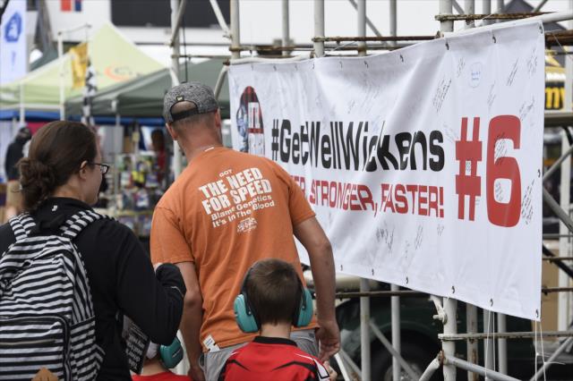 Fans look over the #GetWellWickens banner in the stands at Portland International Raceway -- Photo by: Chris Owens