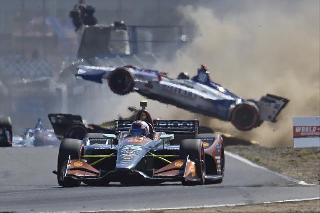 Zach Veach escapes the Lap 1 carnage as Marco Andretti goes airborne in Turn 3 during the Grand Prix of Portland at Portland International Raceway -- Photo by: Chris Owens