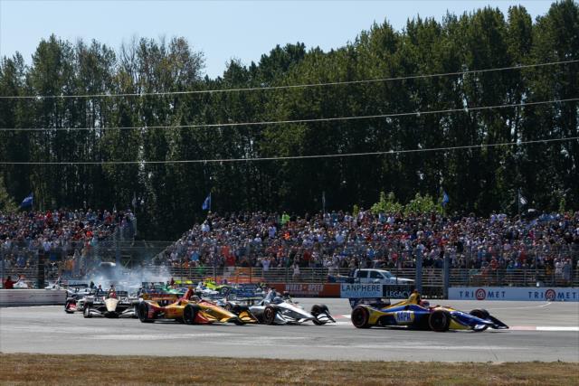 Alexander Rossi leads a train of cars into the Festival Curves (Turns 1-2-3) during the start of the Grand Prix of Portland at Portland International Raceway -- Photo by: Joe Skibinski