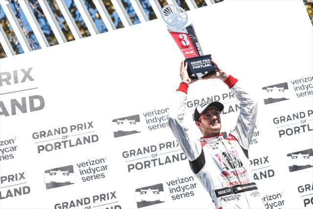 Sebastien Bourdais hoists his 2nd Place trophy in Victory Circle following the Grand Prix of Portland at Portland International Raceway -- Photo by: Joe Skibinski
