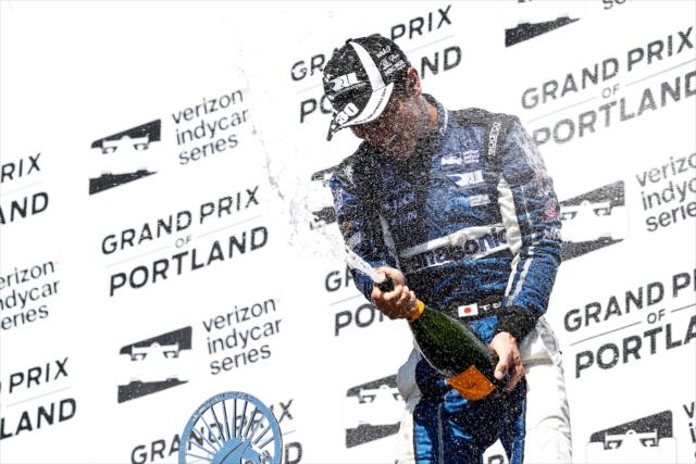 Takuma Sato sprays the champagne in Victory Circle after winning the Grand Prix of Portland at Portland International Raceway -- Photo by: Joe Skibinski