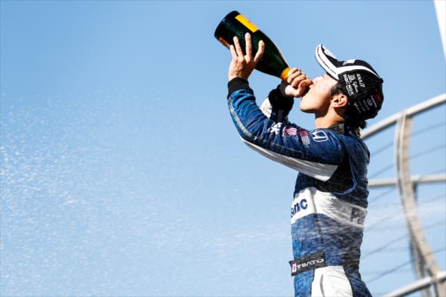 Takuma Sato drinks the champagne in Victory Circle after winning the Grand Prix of Portland at Portland International Raceway -- Photo by: Joe Skibinski
