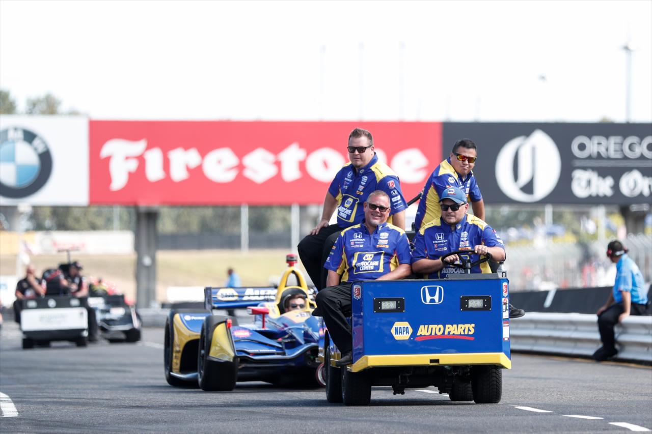 Alexander Rossi's team pulling out their car to pit lane -- Photo by: Joe Skibinski