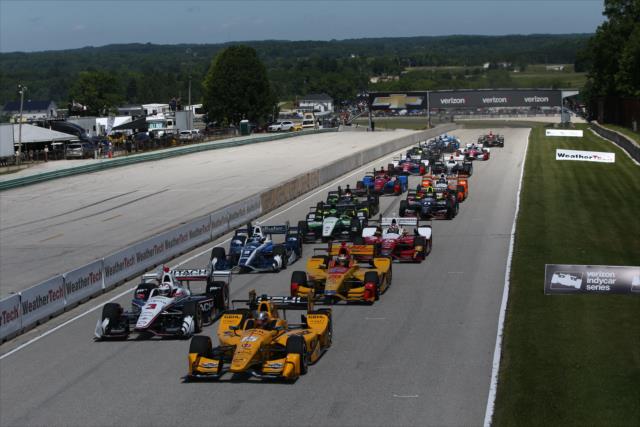 The field streams down the frontstretch to start the KOHLER Grand Prix of Road America -- Photo by: Chris Jones