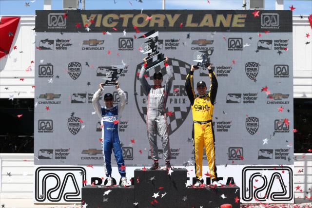 The podium of Will Power, Tony Kanaan, and Graham Rahal hoist their trophies in Victory Lane following the KOHLER Grand Prix of Road America -- Photo by: Chris Jones