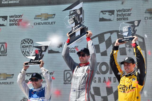 The podium of Will Power, Tony Kanaan, and Graham Rahal hoist their trophies in Victory Lane following the KOHLER Grand Prix of Road America -- Photo by: Chris Owens