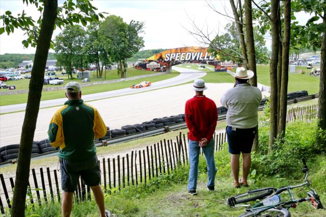 Fans watch Josef Newgarden flow into the Turn 9 Carousel turn during the KOHLER Grand Prix at Road America -- Photo by: Chris Jones