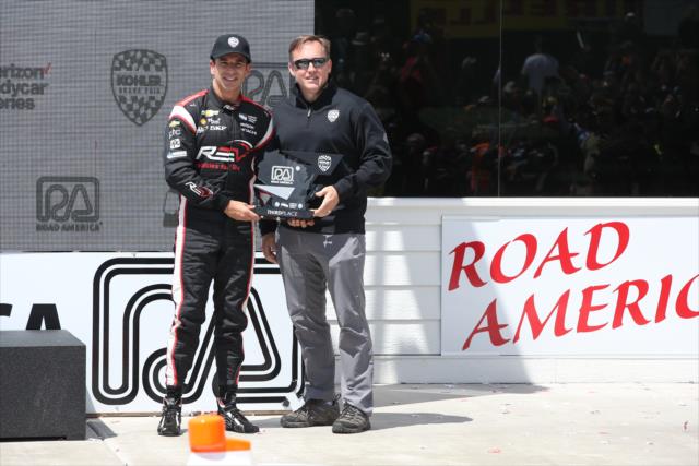 Helio Castroneves accepts his 3rd Place trophy in Victory Circle following the KOHLER Grand Prix at Road America -- Photo by: Chris Jones
