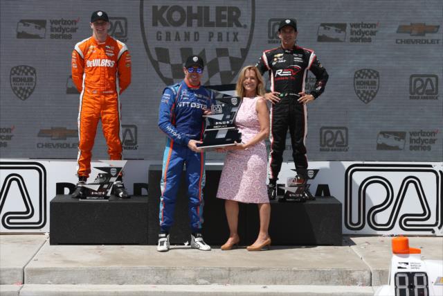 Scott Dixon is presented his winner's trophy in Victory Circle following the KOHLER Grand Prix at Road America -- Photo by: Chris Jones
