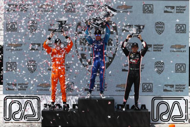 The confetti flies for Scott Dixon, Josef Newgarden, and Helio Castroneves in Victory Circle following the KOHLER Grand Prix at Road America -- Photo by: Chris Jones