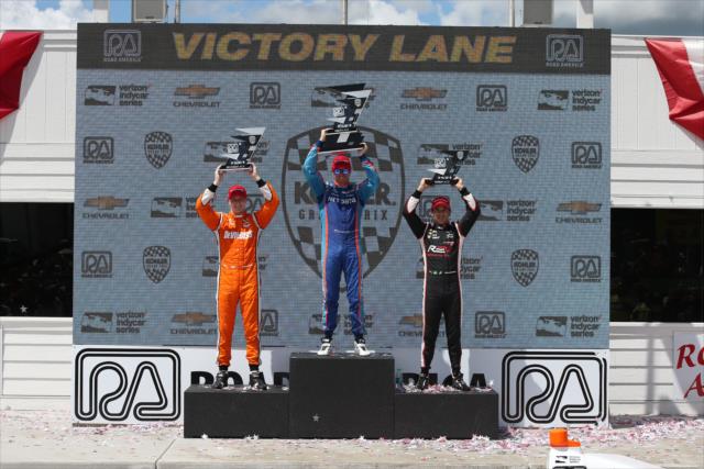 Scott Dixon, Josef Newgarden, and Helio Castroneves hoist their trophies in Victory Circle following the KOHLER Grand Prix at Road America -- Photo by: Chris Jones