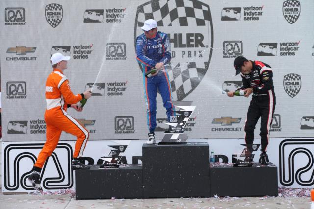 The champagne flies in Victory Circle for Scott Dixon, Josef Newgarden, and Helio Castroneves following the KOHLER Grand Prix at Road America -- Photo by: Chris Jones