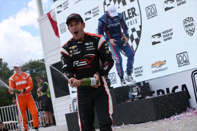 Helio Castroneves sprays the champagne in Victory Circle following his 3rd place finish in the KOHLER Grand Prix at Road America -- Photo by: Joe Skibinski