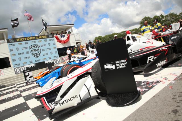 The machines of Helio Castroneves, Scott Dixon, and Josef Newgarden are parked in Victory Circle following the KOHLER Grand Prix at Road America -- Photo by: Matt Fraver