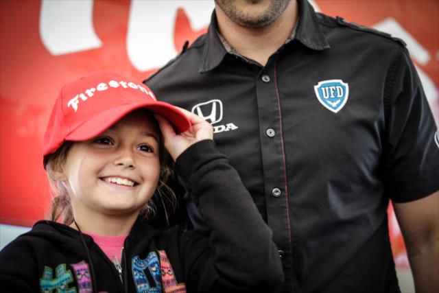 A young fan gets a picture with Marco Andretti in the Firestone Fan Village at Road America -- Photo by: Shawn Gritzmacher