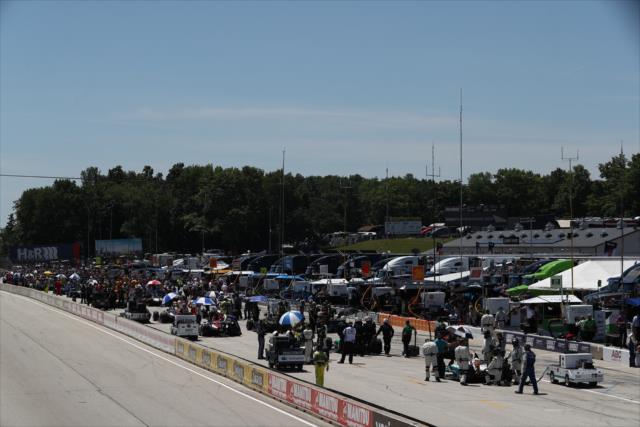 Pit lane comes to life as cars wait on the grid during pre-race festivities for the KOHLER Grand Prix at Road America -- Photo by: Chris Jones