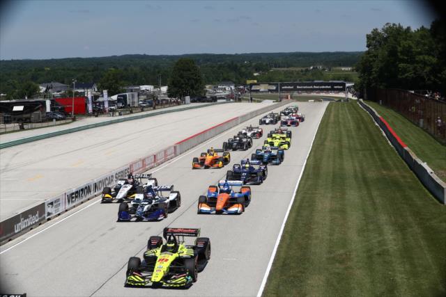 The field screams down the frontstretch to start the KOHLER Grand Prix at Road America -- Photo by: Chris Jones