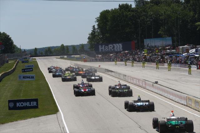 The field screams toward Turn 1 during the start of the KOHLER Grand Prix at Road America -- Photo by: Chris Jones