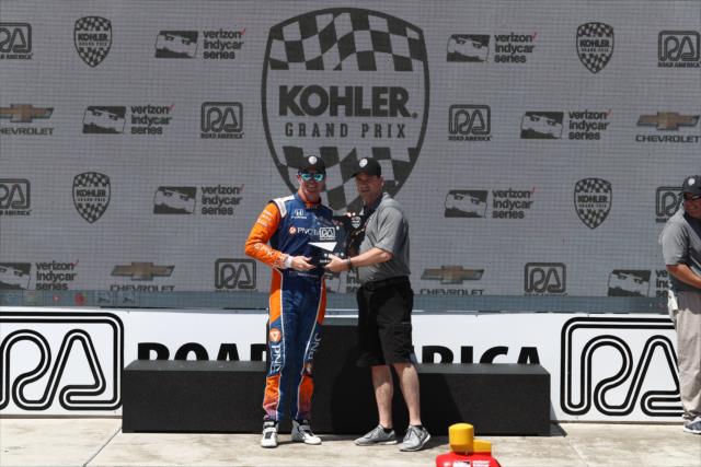 Scott Dixon is presented his 3rd Place trophy in Victory Lane following the KOHLER Grand Prix at Road America -- Photo by: Chris Jones