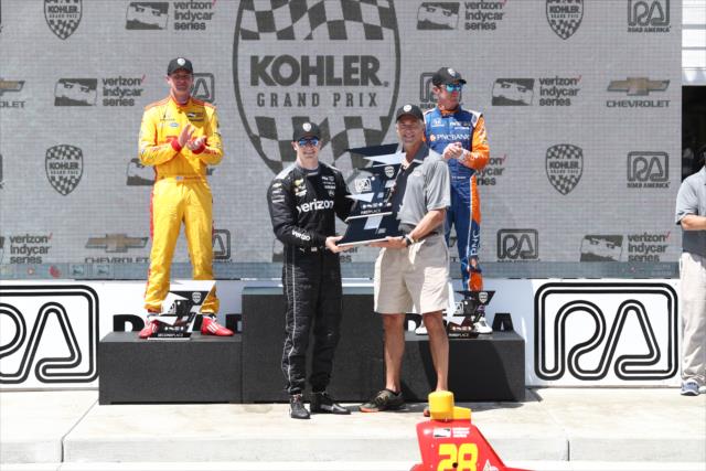 Josef Newgarden is presented his 1st Place trophy in Victory Lane after winning the KOHLER Grand Prix at Road America -- Photo by: Chris Jones
