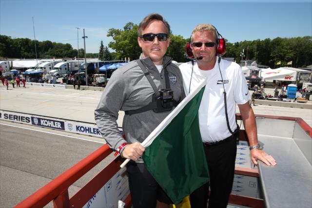 Brian Melka, President, Kohler Engines America, ready to fly the green flag as the honorary starter of the KOHLER Grand Prix at Road America -- Photo by: Chris Jones
