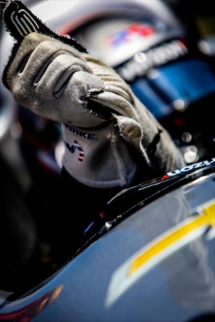 Josef Newgarden begins taking off his gloves in Victory Lane after winning the KOHLER Grand Prix at Road America -- Photo by: Shawn Gritzmacher