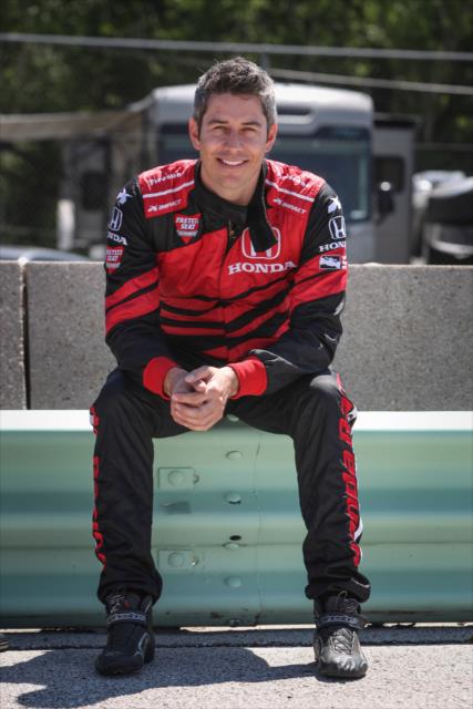 Arie Luyendyk Jr. sits along pit lane wall prior to piloting the two-seater during pre-race festivities for the KOHLER Grand Prix at Road America -- Photo by: Shawn Gritzmacher