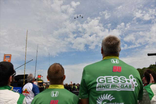 Two members of the Harding Steinbrenner team watch the fly over. -- Photo by: John Cote