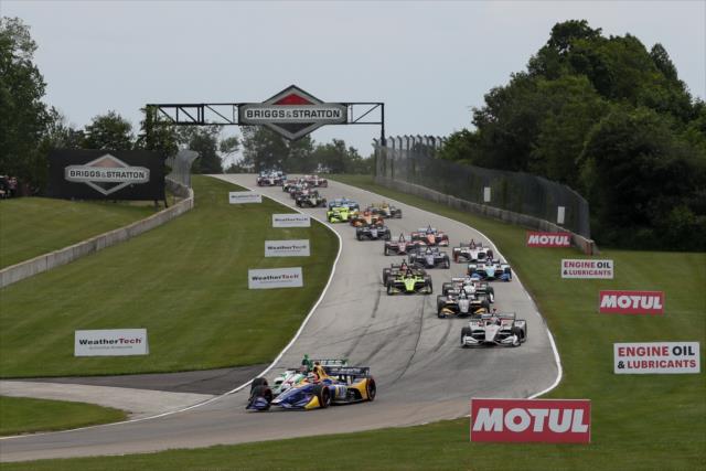 Alexander Rossi passing Colton Herta in turn 3 on the first lap of the REV Group Grand Prix at Road America. -- Photo by: Joe Skibinski
