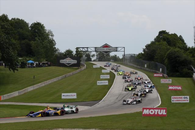 Alexander Rossi passing Colton Herta on the first lap of the REV Group Grand Prix at Road America. -- Photo by: Joe Skibinski