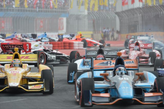 Alex Tagliani and Ryan Hunter-Reay lead the field as Helio Castroneves spins -- Photo by: John Cote