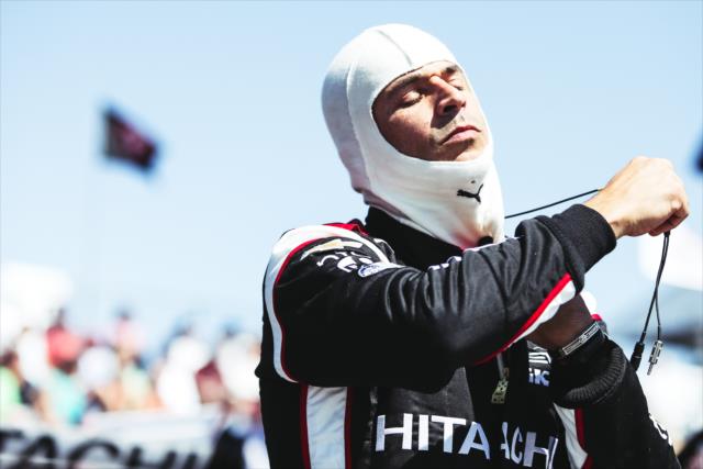 Helio Castroneves adjusts his balaclava on pit lane prior to practice for the Firestone Grand Prix of St. Petersburg -- Photo by: Joe Skibinski
