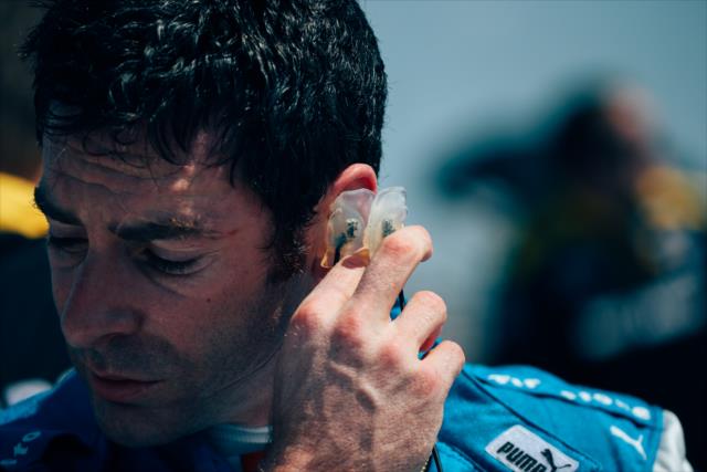Simon Pagenaud removes his earpieces on pit lane following practice for the Firestone Grand Prix of St. Petersburg -- Photo by: Joe Skibinski