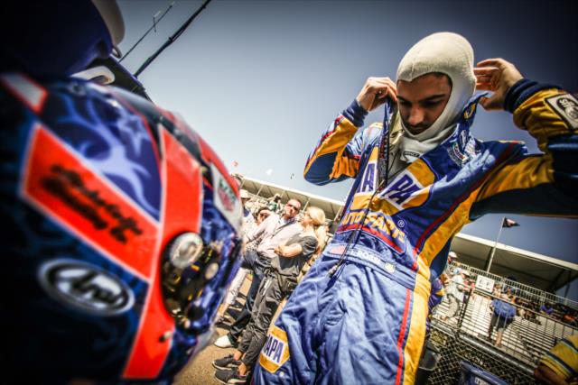 Alexander Rossi adjusts his firesuit along pit lane prior to practice for the Firestone Grand Prix of St. Petersburg -- Photo by: Shawn Gritzmacher