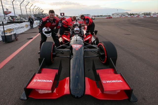 Mark Schlereth of ESPN, poses in front of the two seater ride right after finishing a few laps around the track with Mario Andretti driving before the Firestone Grand Prix of St. Petersburg. -- Photo by: Joe Skibinski