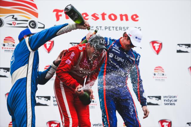 Sebastien Bourdais receives a champagne shower in Victory Circle from Simon Pagenaud and Scott Dixon -- Photo by: Joe Skibinski