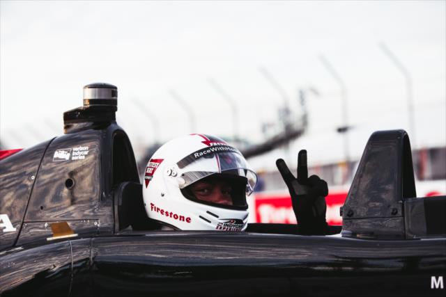 Vincent Jackson waving while taking a lap around the Firestone Grand Prix of St. Petersburg in the two seater car driven by Mario Andretti. -- Photo by: Joe Skibinski