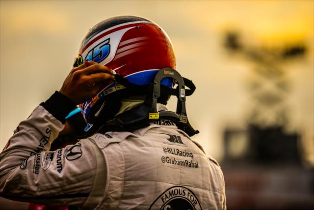 Graham Rahal attaches his head restraint system to his helmet prior to the final warmup for the Firestone Grand Prix of St. Petersburg -- Photo by: Shawn Gritzmacher