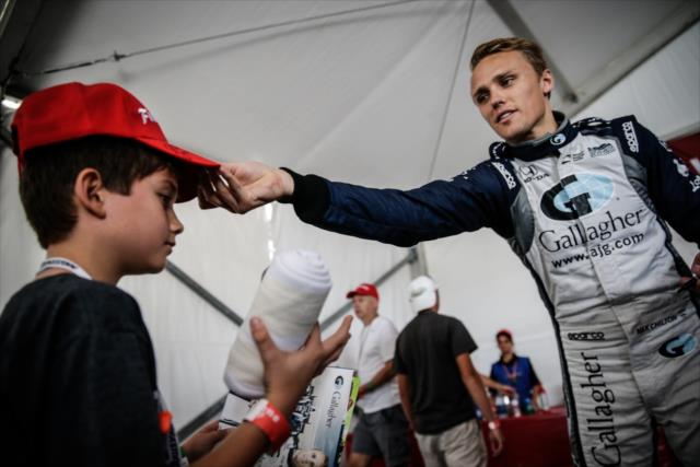 Max Chilton places a Firestone hat on a young fan following a Q&A in the Firestone hospitality tent in St. Petersburg -- Photo by: Shawn Gritzmacher