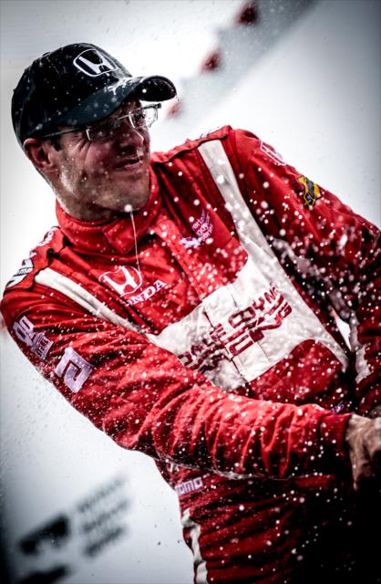 Sebastien Bourdais lets the champagne fly in Victory Circle following his win in the Firestone Grand Prix of St. Petersburg -- Photo by: Shawn Gritzmacher