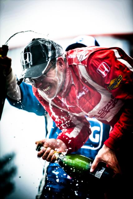 Sebastien Bourdais receives a champagne shower in Victory Circle following his win in the Firestone Grand Prix of St. Petersburg -- Photo by: Shawn Gritzmacher