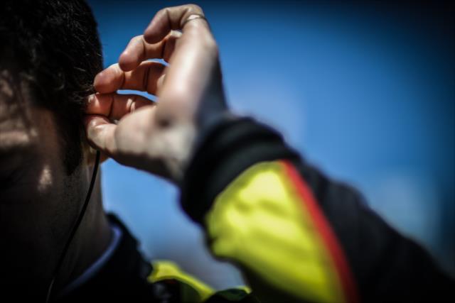 Simon Pagenaud inserts his earpieces along pit lane prior to practice for the Firestone Grand Prix of St. Petersburg -- Photo by: Shawn Gritzmacher
