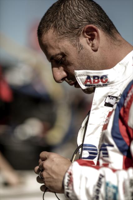 Tony Kanaan preps his earpieces along pit lane prior to practice for the Firestone Grand Prix of St. Petersburg -- Photo by: Shawn Gritzmacher