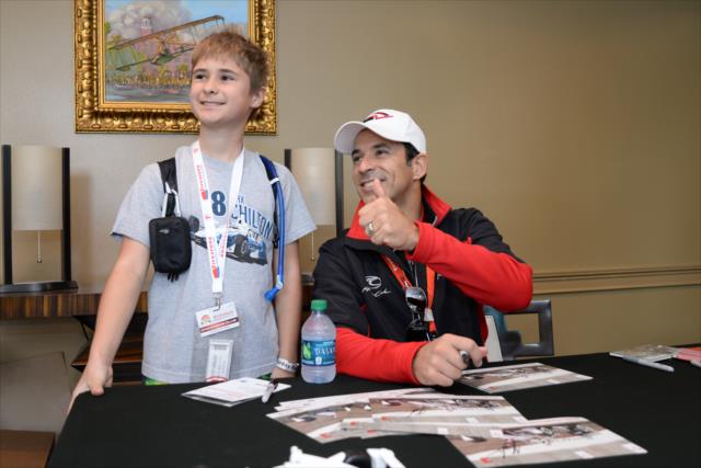Helio Castroneves poses for a photograph during an autograph session in St. Petersburg -- Photo by: James  Black