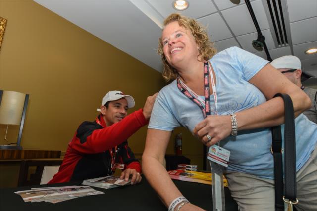 Helio Castroneves signs an autograph for a fan during an autograph session at St. Petersburg -- Photo by: James  Black
